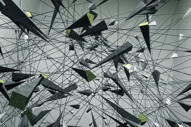 Gray and green pyramids strewn about a web or black lines in a gray room. 