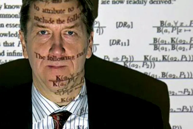 Selmer Bringsjord with equations projected over his face. 
