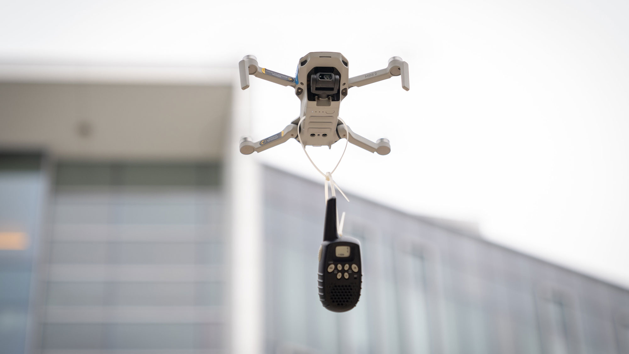 a drone flying with a walkie talkie
