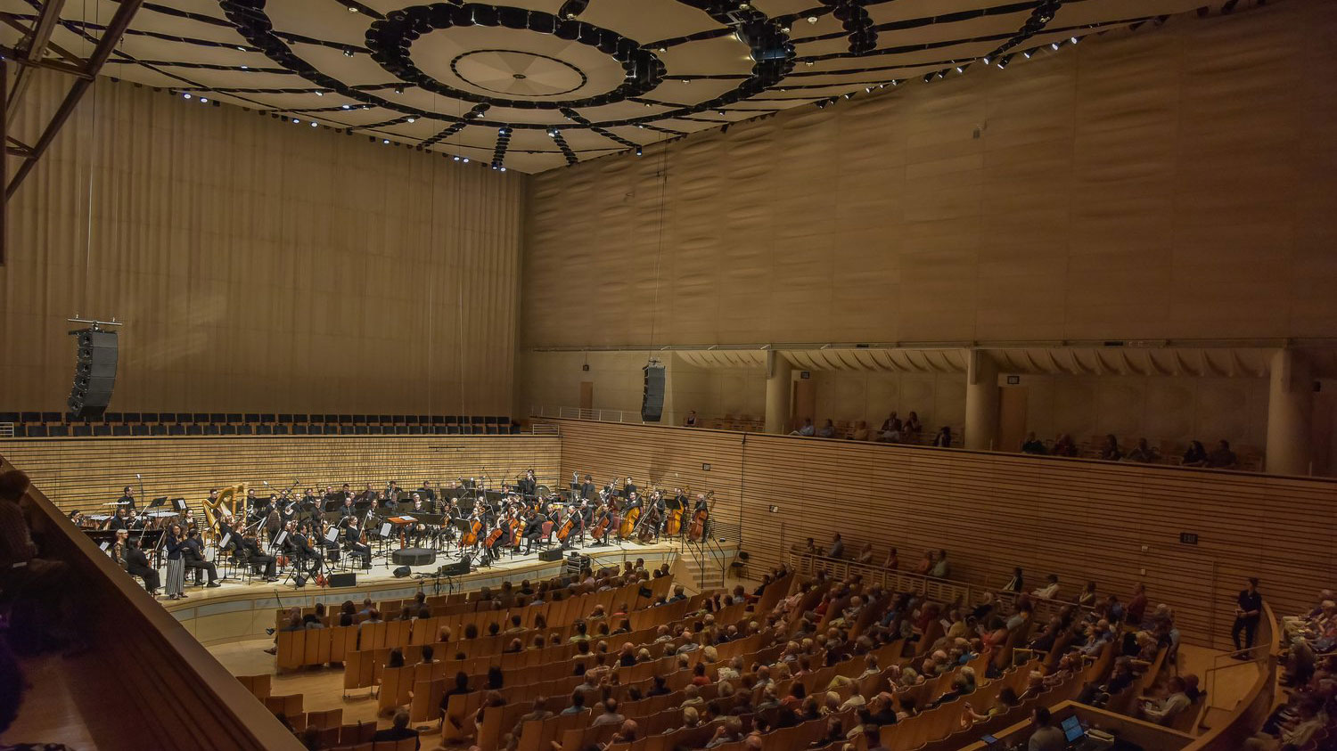 ASO's full orchestra on EMPAC's concert hall stage with a large audience.