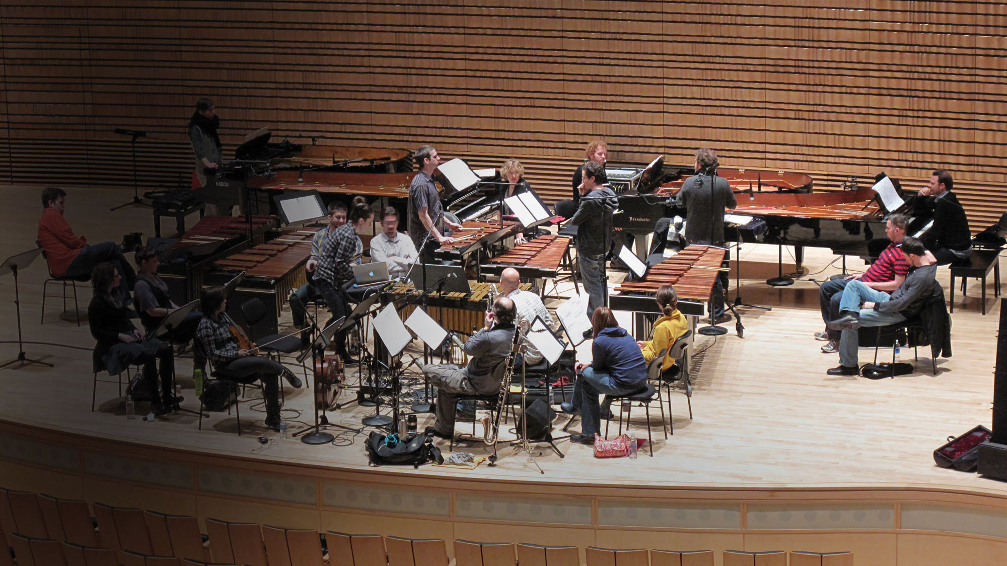 An ensemble practicing on the concert hall stage. 