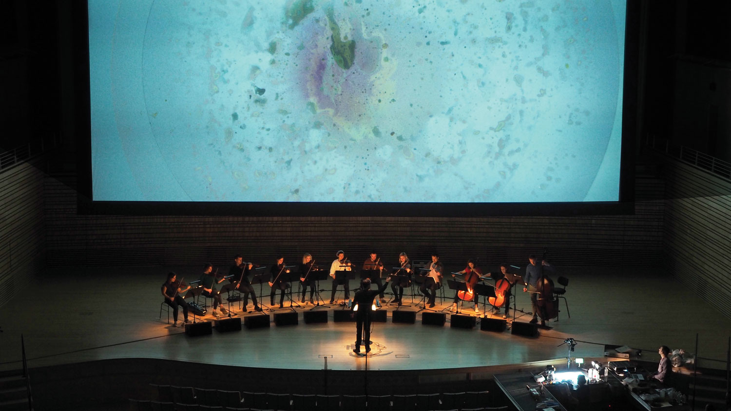 Ensemble Signal seated in a semi circle on stage recording in the concert hall. 