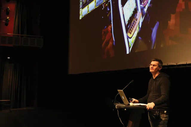 Patrick Keilty in the theater giving a lecture.