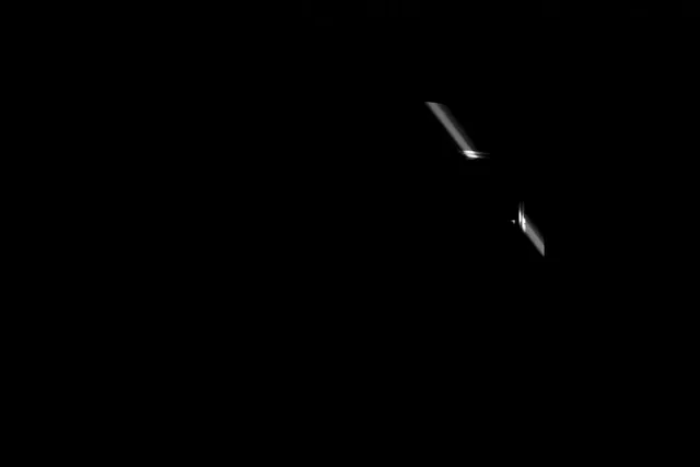 a whisp of white light in solid darkness