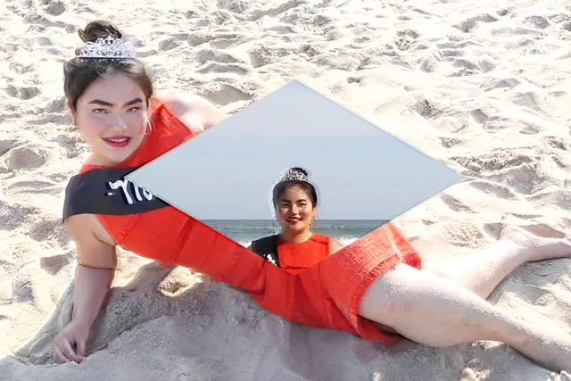 A Vietnamese woman laying on a beach in a red dress with a tiara, A diamond is superimposed over her body with another image of her face. 