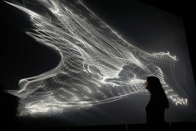 a woman viewing a light installation