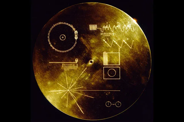 A gold disk with various etchings. The Sounds of Earth Record Cover from Voyager 1 and 2