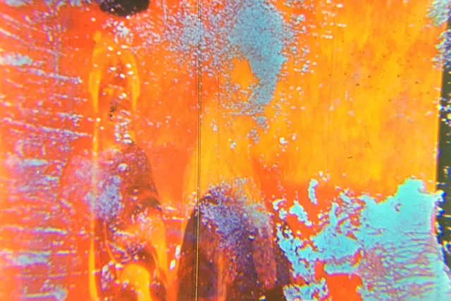 An abstract orange and teal ink and oil blob. 