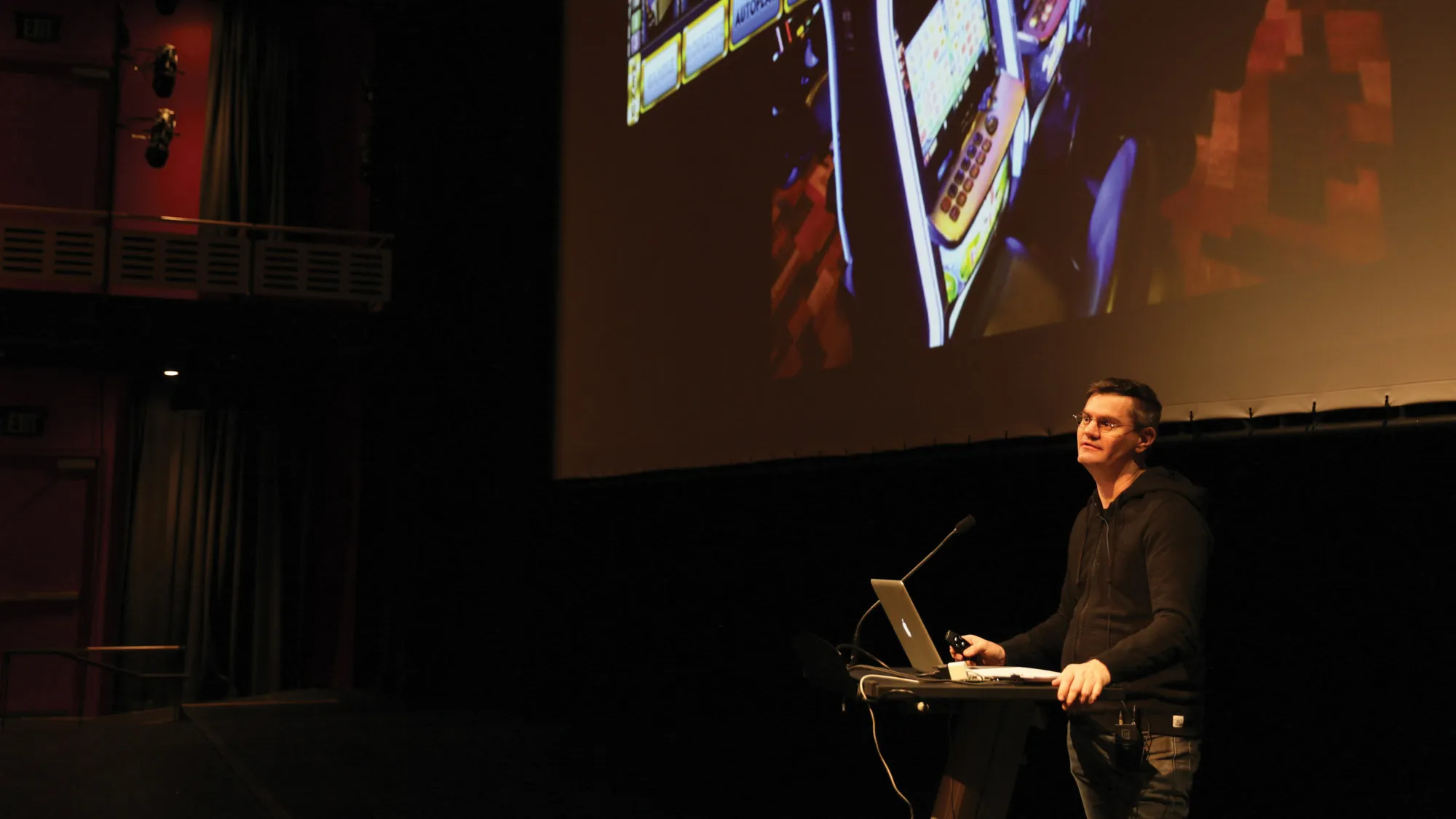 Patrick Keilty in the theater giving a lecture. 