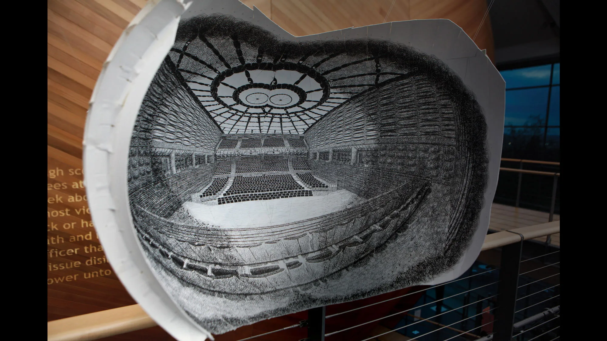 A black and white sketch model of the concert hall set in front of the completed concert hall. 