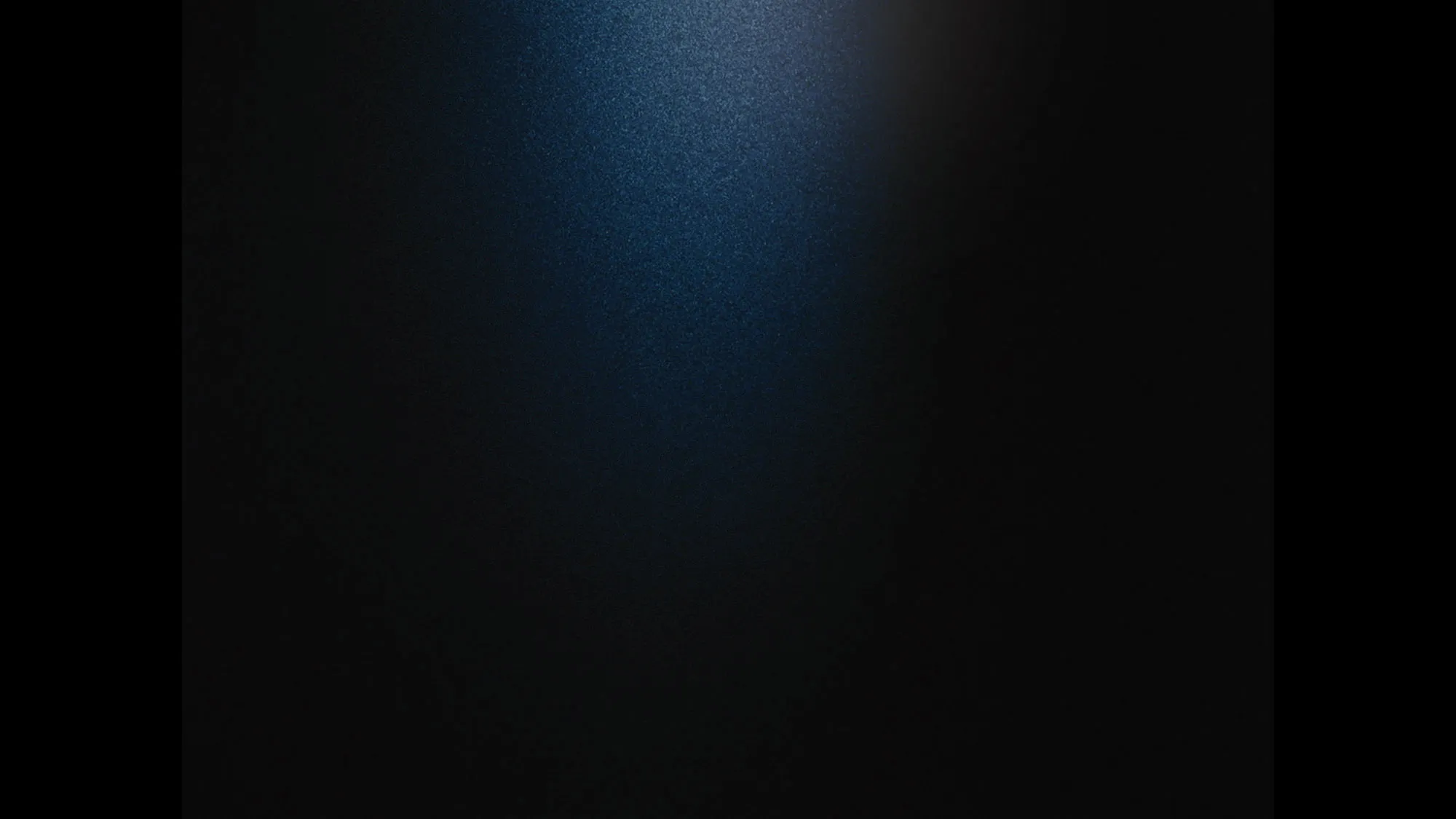 A black screen with a slight beam of light in the center.